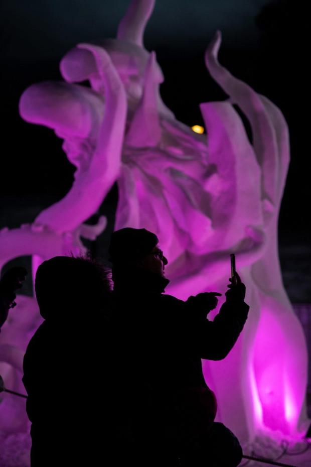 BRECKENRIDGE, COLORADO - JANUARY 25: People take photos during the 29th International Snow Sculpture Championships Friday, Jan. 25, 2019 in Breckenridge. Sixteen teams competed by hand-carving a 20-ton block of ice. The event is free and viewing days are Jan 25-30. (Photo by Daniel Brenner/Special to the Denver Post)