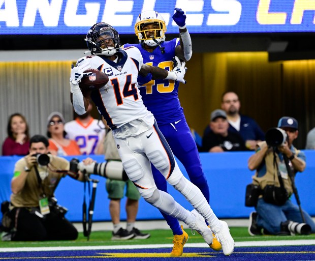 Denver Broncos wide receiver Courtland Sutton (14) makes a one-handed catch for a touchdown against Los Angeles Chargers cornerback Michael Davis (43) in the third quarter at SoFi Stadium in Inglewood, California Sunday, Dec. 10, 2023. (Photo by Andy Cross/The Denver Post)