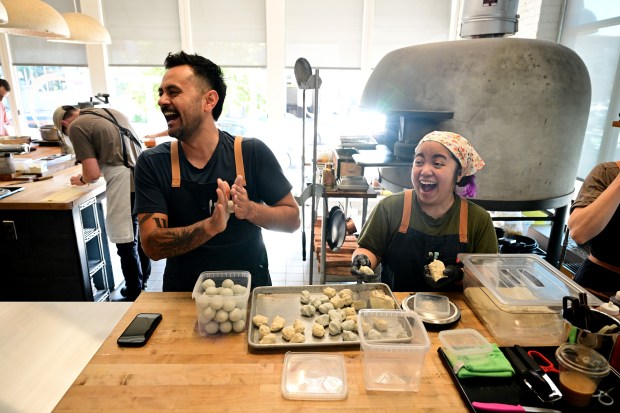 Brutø executive chef Michael Diaz de Leon, center, pastry chef Yna Zuniga, right, have a laugh together as they prepare house-made masa balls for tortillas at Brutø in Denver on Sept. 13, 2023. (Photo by Helen H. Richardson/The Denver Post)