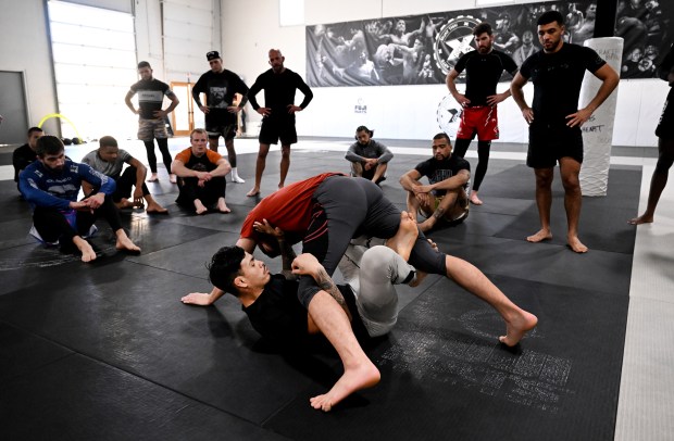 Brandon Royval, on his back, demonstrates technique to other fighters with Clay Matza, during daily training session at Factory X on December 6, 2023 in Englewood, Colorado. (Photo by Helen H. Richardson/The Denver Post)"