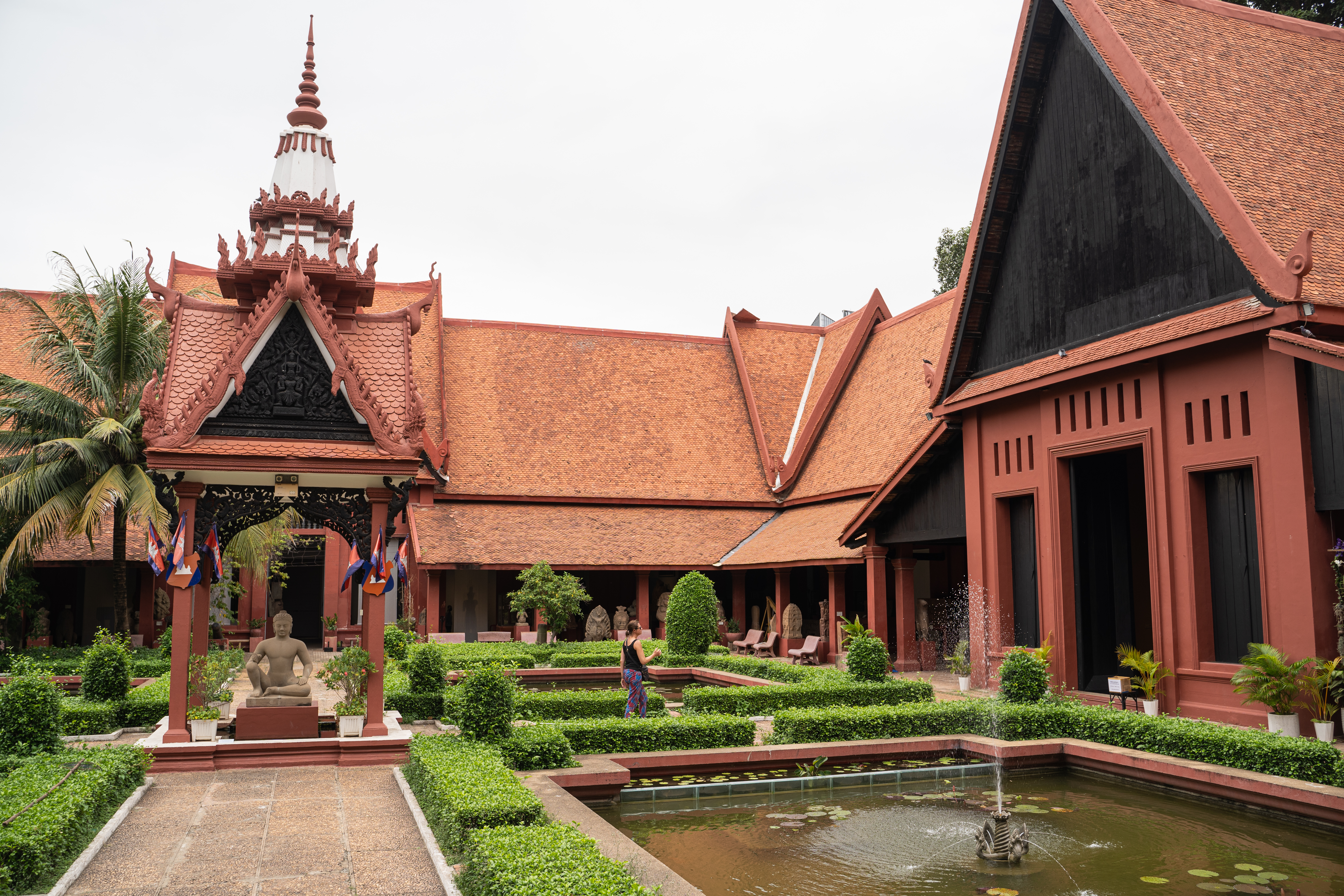 A visitor walks through the inner courtyard of the National Museum of Cambodia in Phnom Penh Aug. 8, 2022. (Photo by Cindy Liu/Special to The Denver Post)