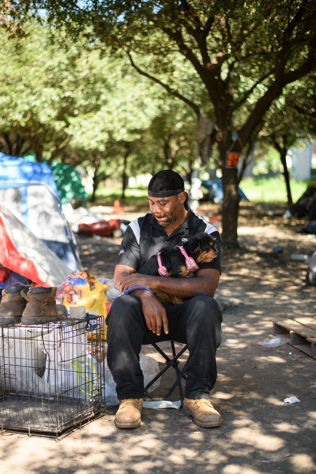 Ronald Whitley poses for a portrait with her dog Ann in Houston on Oct. 14, 2023. Whitley was homeless at the time, living in a tent with her wife and dog at a homeless encampment. (Photo by Mark Felix/Special to The Denver Post)